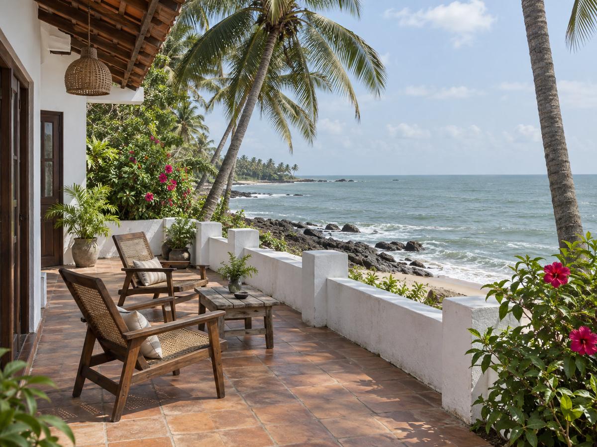 Ambalangoda beachfront terrace in late-morning light, coconut palms and a calm grey-green sea