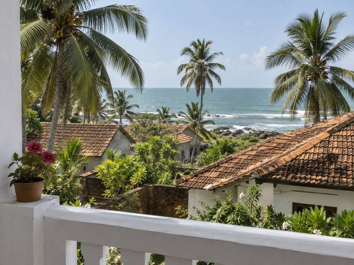 View from a balcony across rooftops of clay tiles to the Indian Ocean